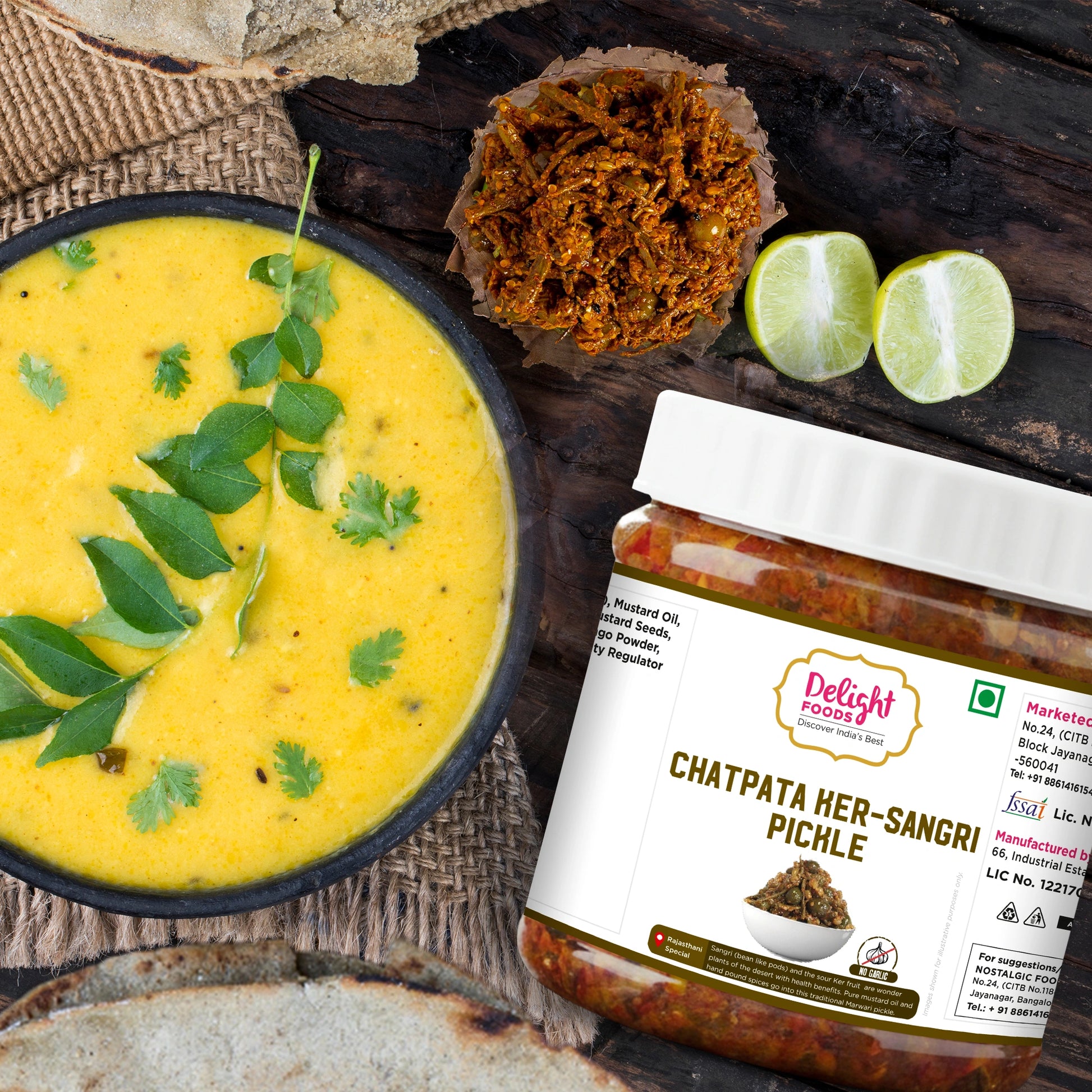 Jar of Chatpata ker Sangri Pickle with a bowl of yellow soup and ingredients on a wooden surface